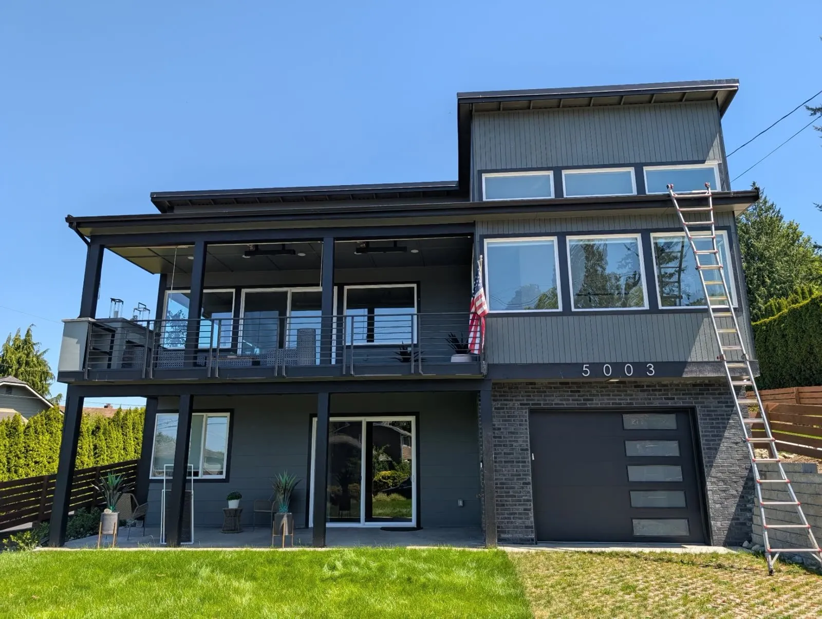 Dark toned Pacific Northwest home with glass deck railing after a residential window cleaning in Mukilteo