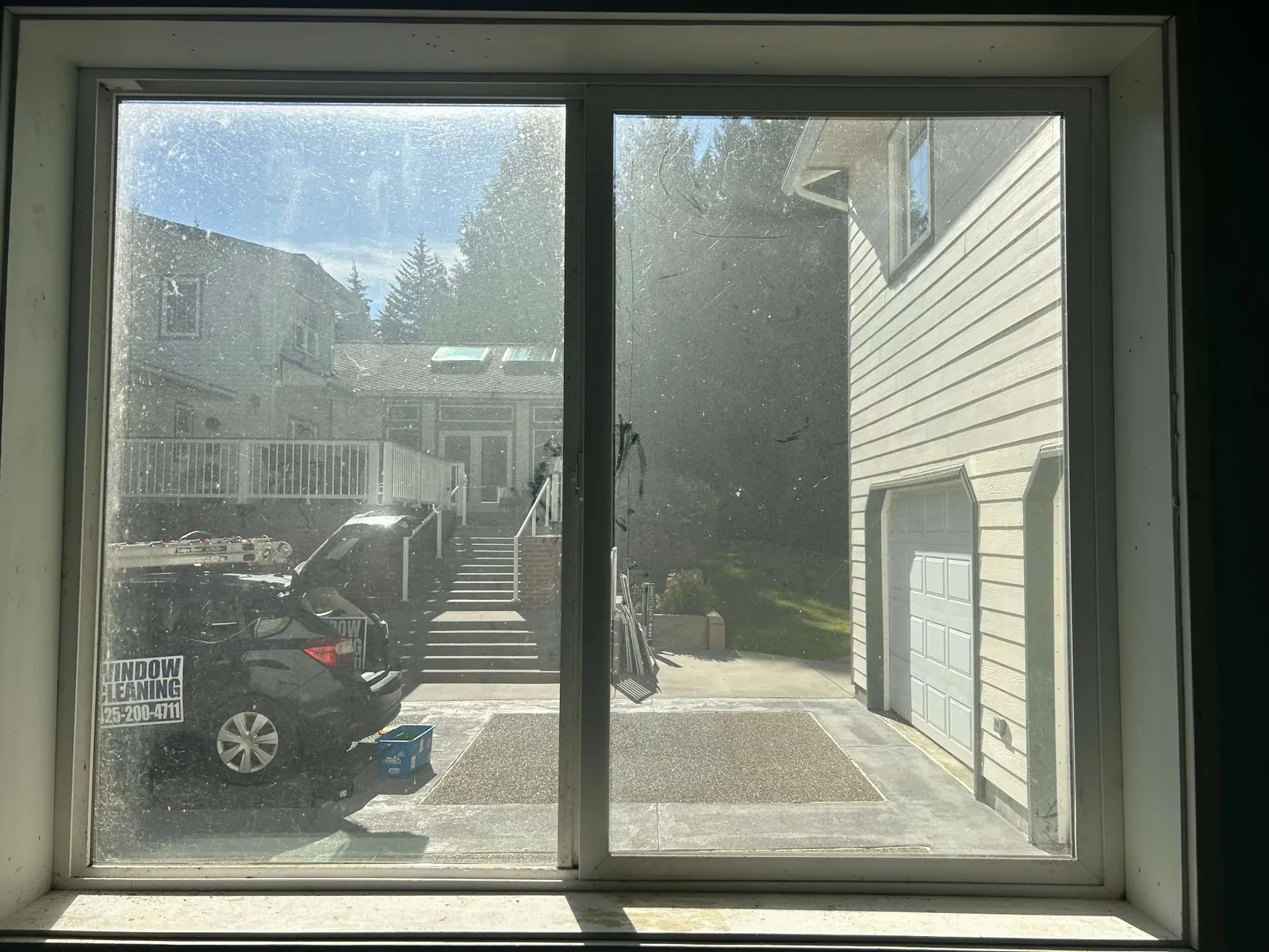 Residential picture window before window cleaning, covered in grime