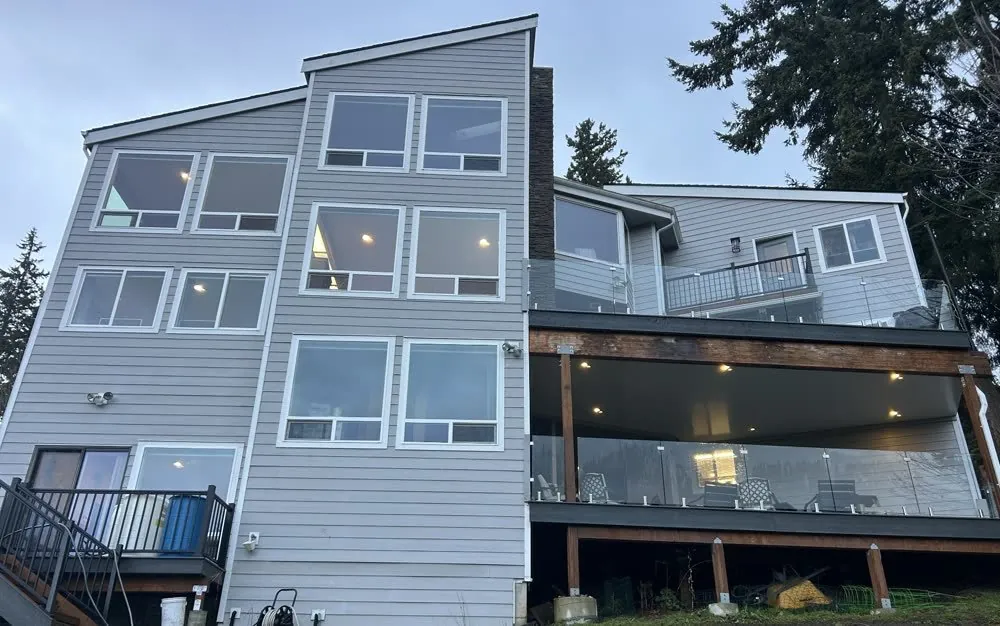 Three story home with high geometric windows reached by water fed pole systems in Seattle