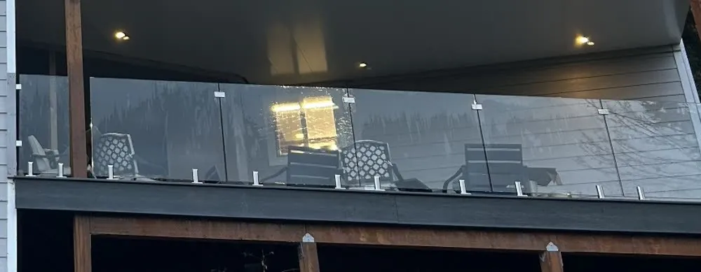 Close crop of a spotless glass deck railing and a freshly detailed window track